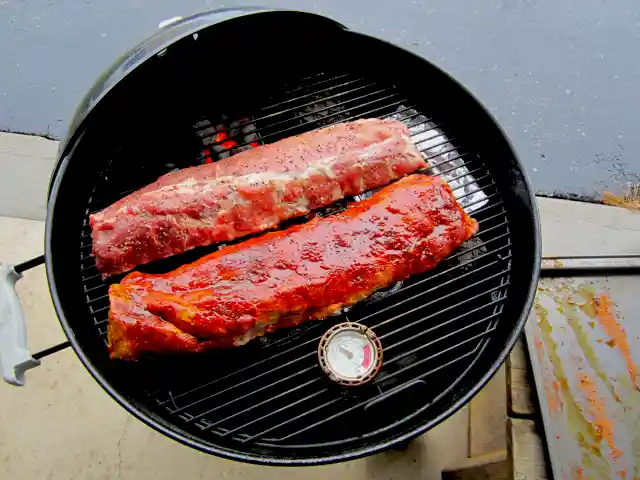 Oven Thermometer on a 22 inch Weber charcoal grill grate with bbq ribs