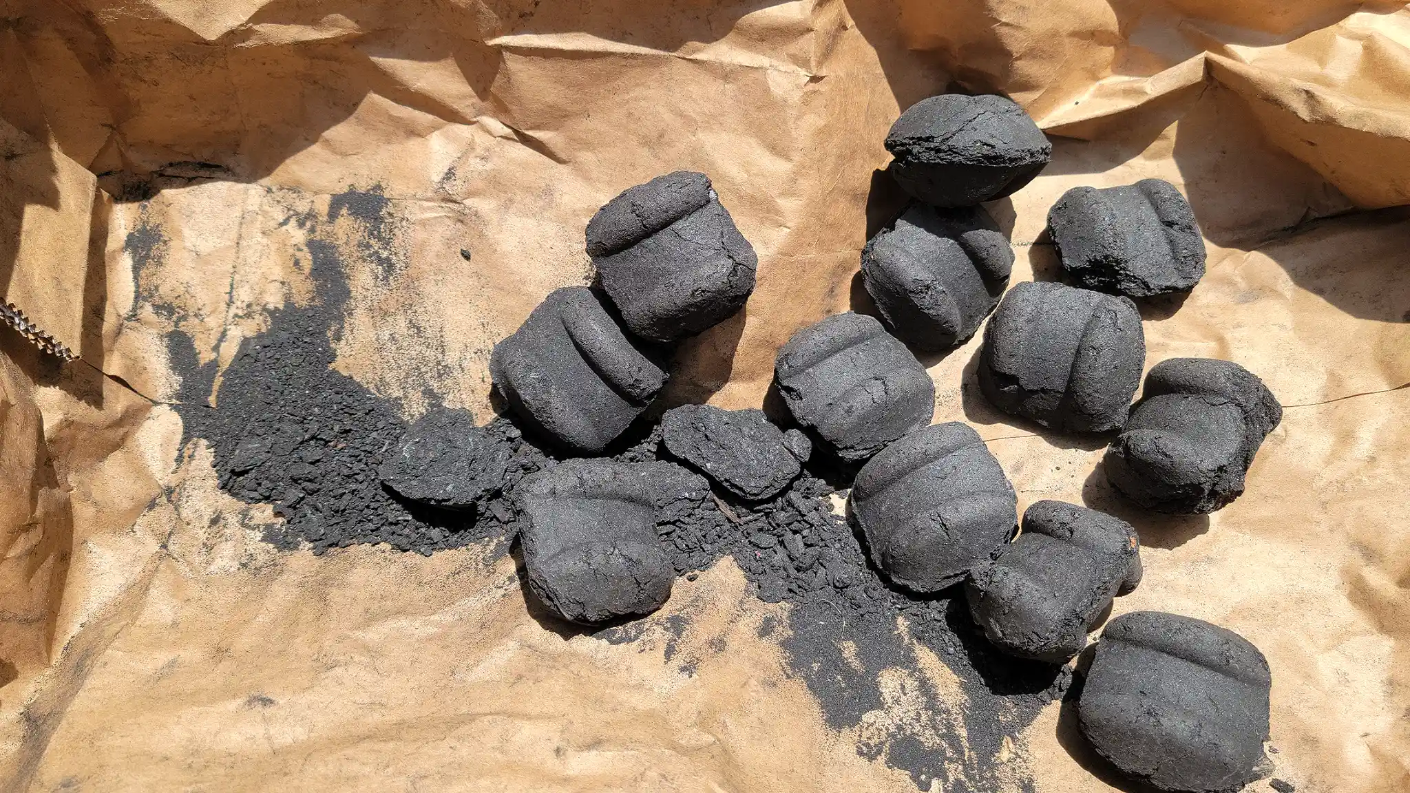 Remains of the Royal Oak SUPER SIZE charcoal briquettes show very little dust at the end of the bag